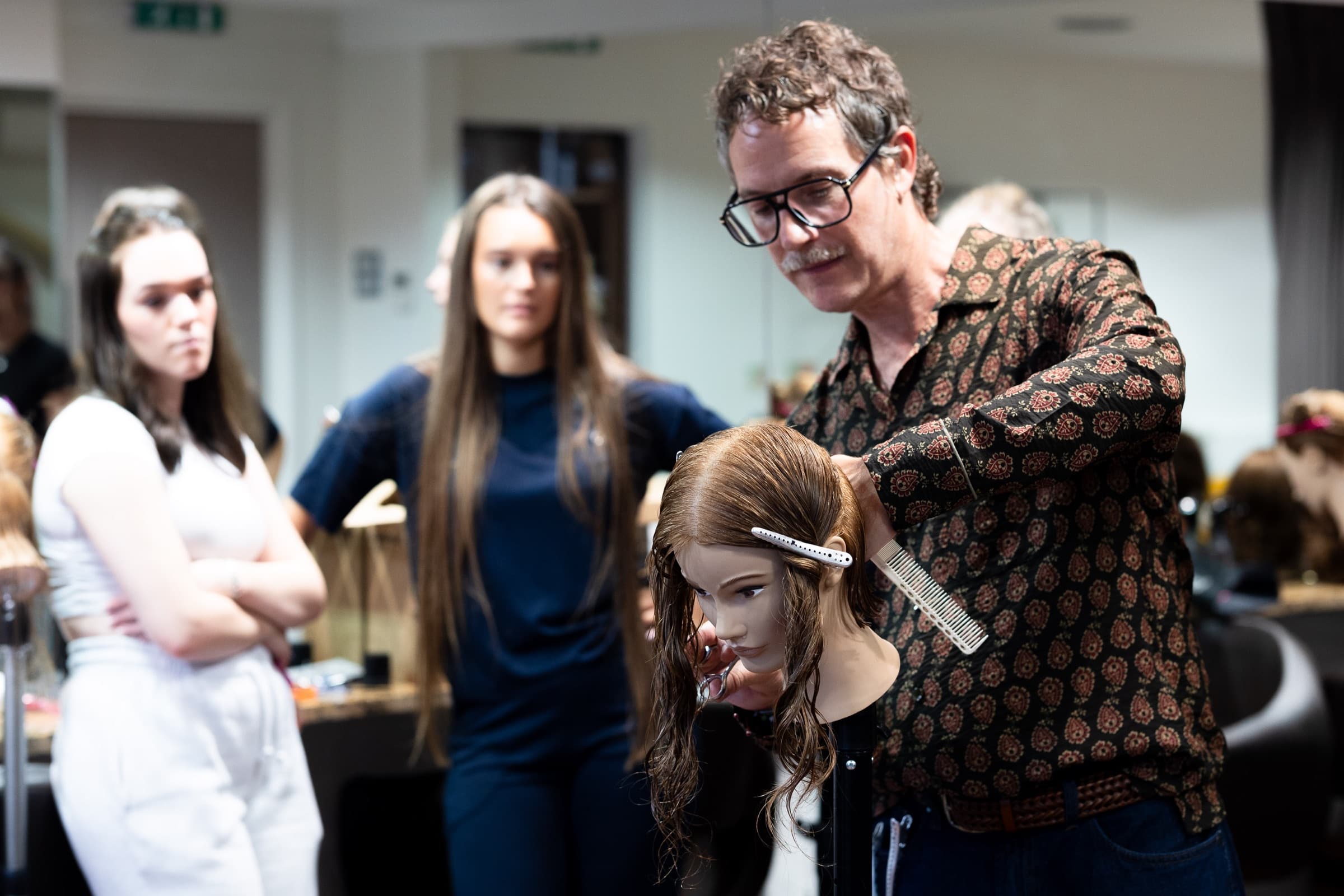 An educator demonstrating a cutting technique